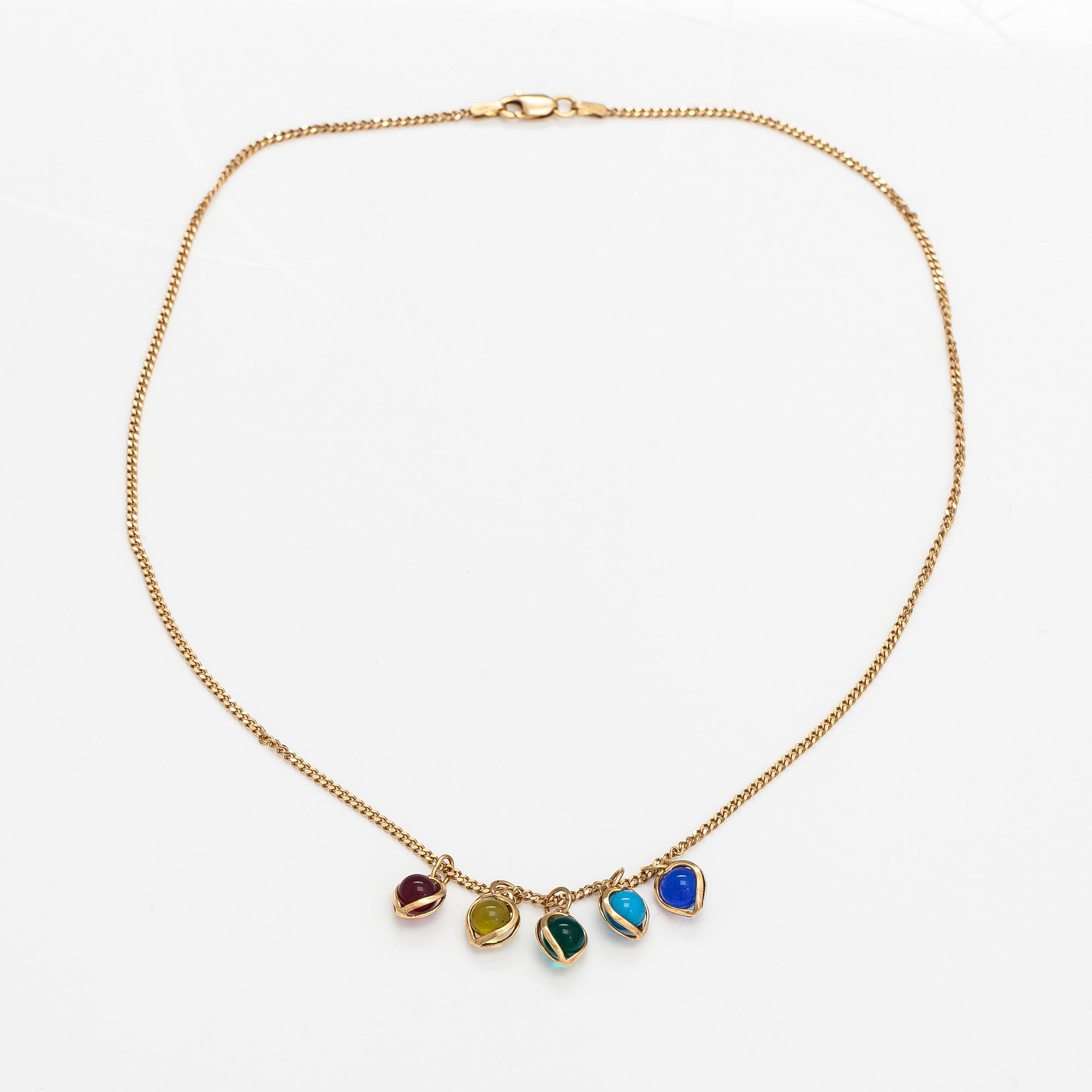 A 14K gold neckalce with glass pearls.