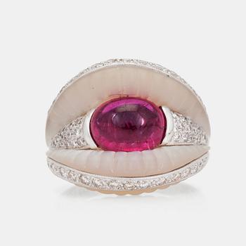 A cabochon cut pink tourmaline, mother of pearl and diamond ring.