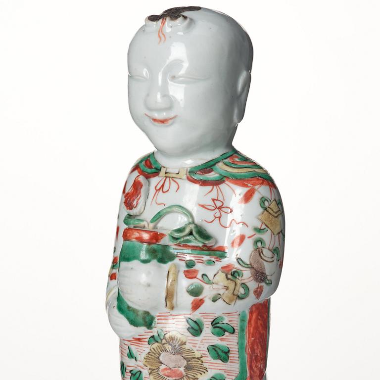 A wucai decorated porcelain figure of a laughing boy, 17th Century.