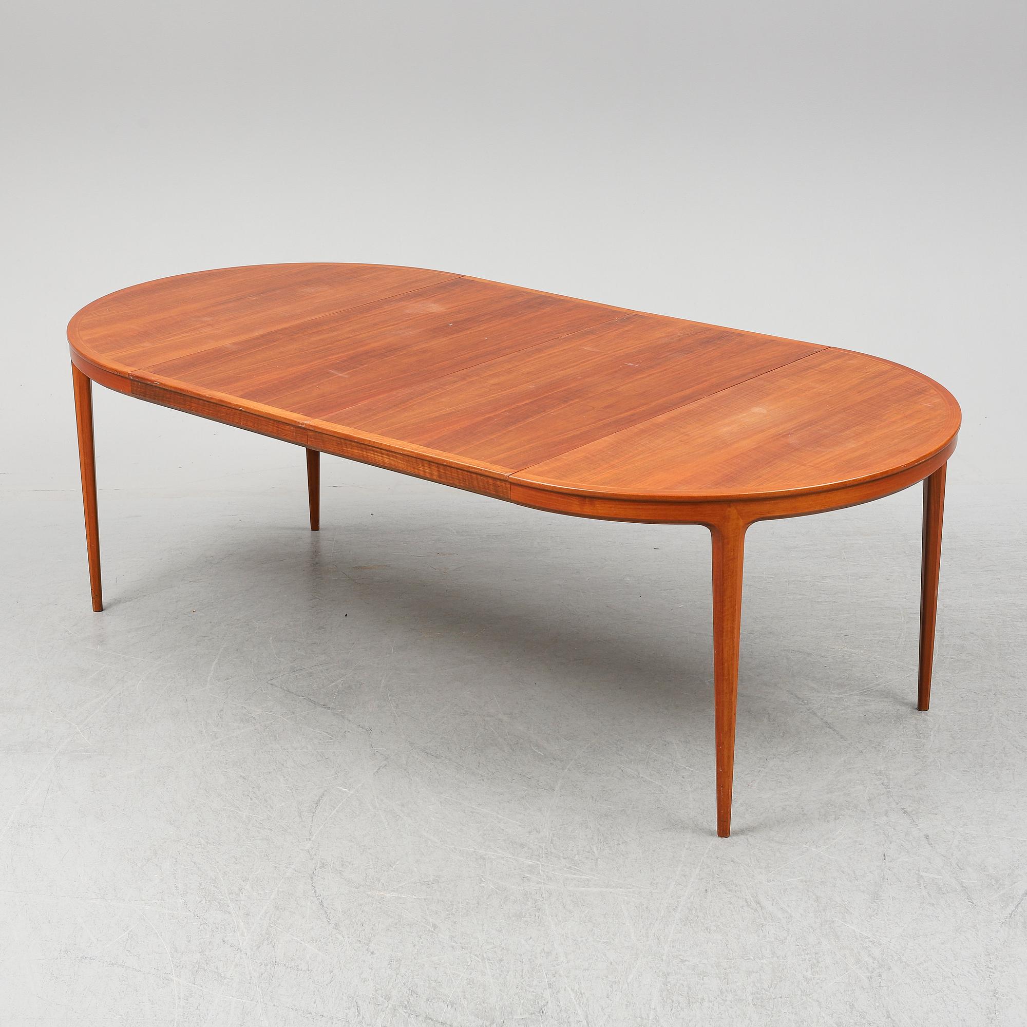 BERTIL FRIDHAGEN, a seven  piece walnut dining suite from Bodafors.