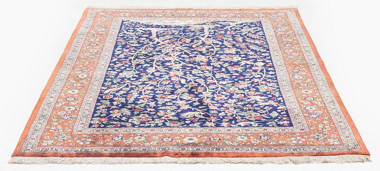 A signed pictoral silk Qum rug, c. 203 x 127 cm.