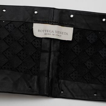 BOTTEGA VENETA, a black leather cover for the steering wheel.