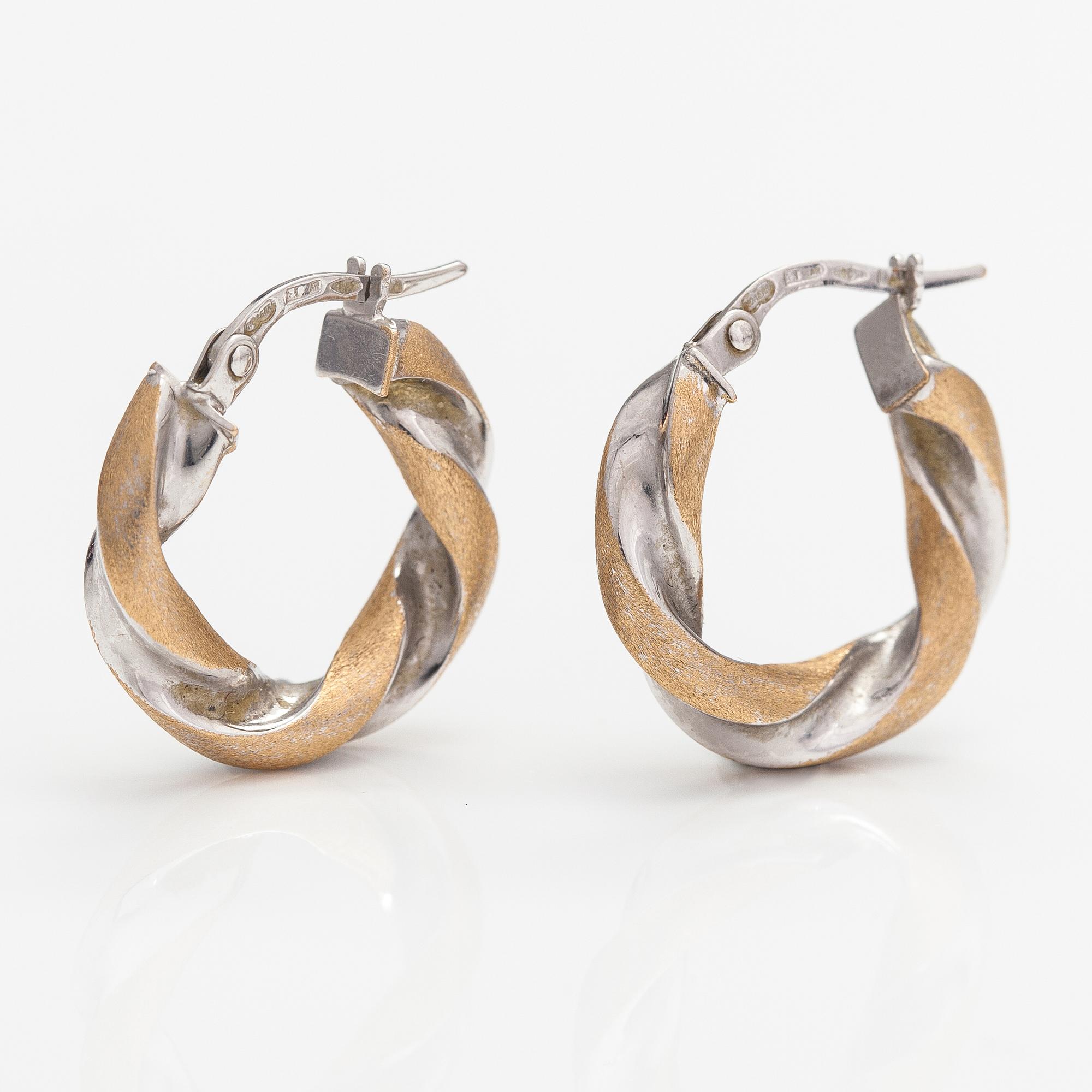 A pair of 14K white and yellow gold earrings. Unoaerre, Italy.