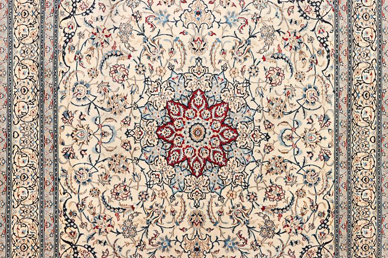A Nain carpet, part silk, 9 laa, c. 390 x 295 cm.