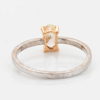 Oval diamond and brilliant-cut diamond ring.