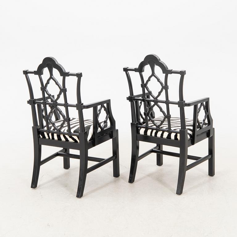 A pair of modern Eichholtz armchairs.