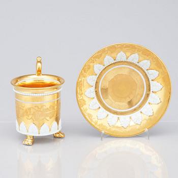 A gilded French Empire cup with stand, 19th Century.