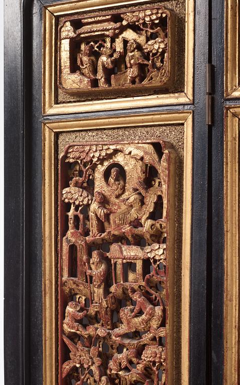 A set of four framed wooden panels, Qing dynasty, 19th Century.