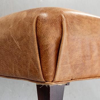 A leather ottoman/coffee table alter part of the 20th century.