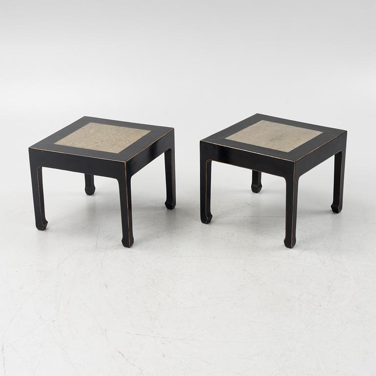 A pair of blac painted side tables with stone tops.