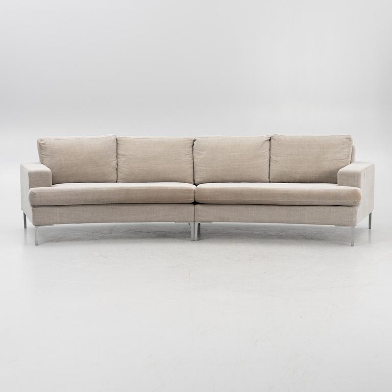 A 'Curve' sofa with a foot stool, Ire, 21st Century.