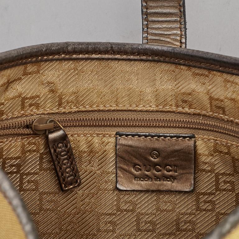 GUCCI, a metallic bag.