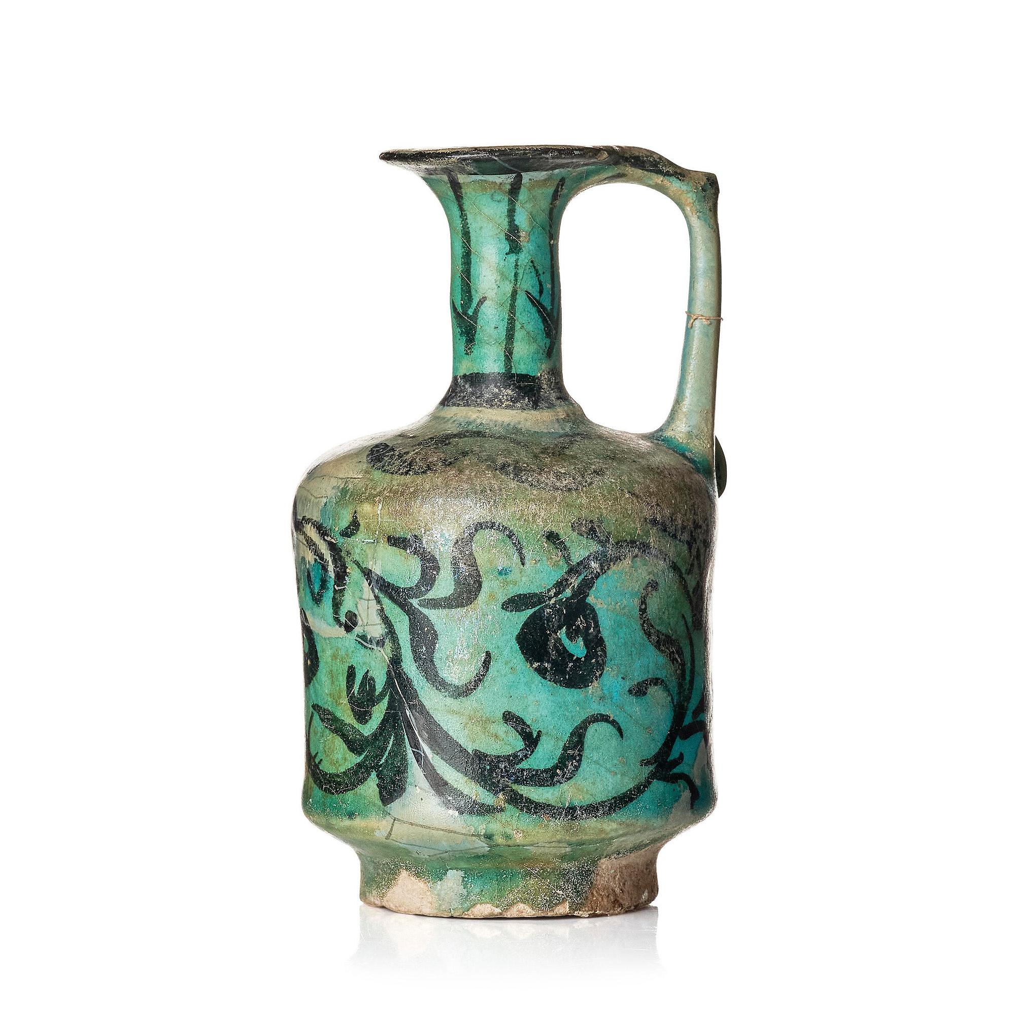 A Kashan turquoise blue-glazed ewer, central Persia (Iran), 11th to 12th century.