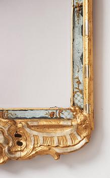 A Swedish rococo giltwood mirror in the manner of E. Göbel, Stockholm, later part 18th century.