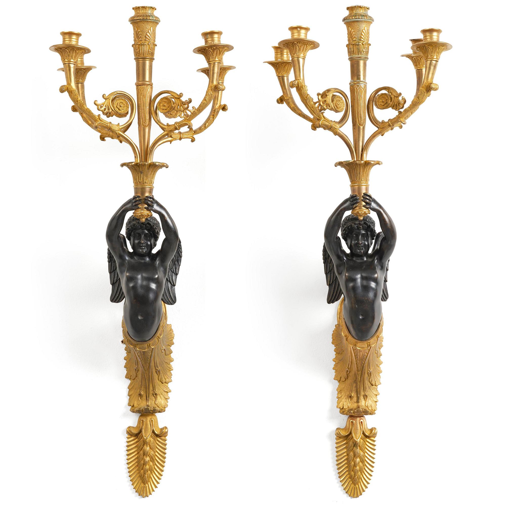 A pair of Napoleon III five-branch gilt and patinated bronze appliques.