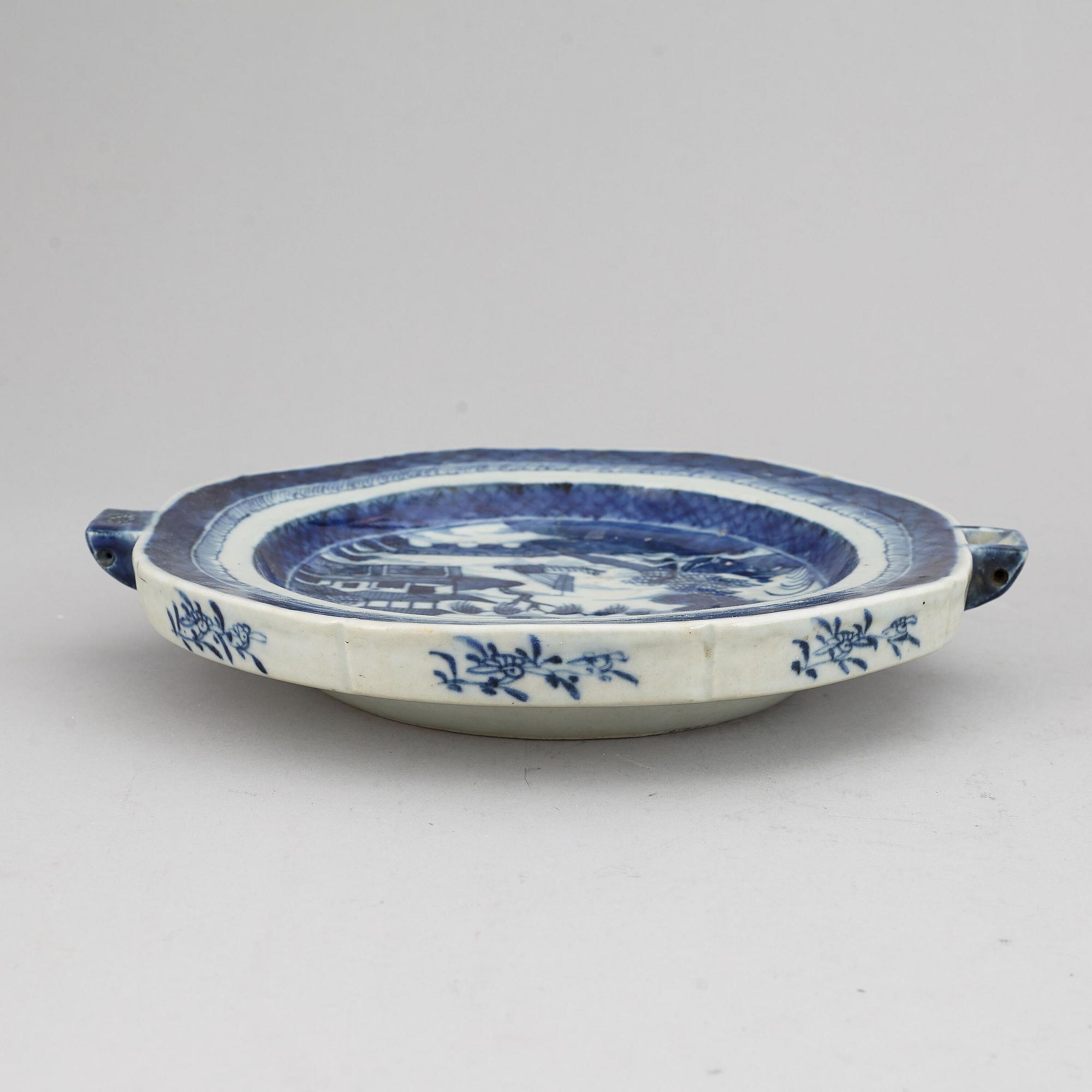 A set of three blue and white plates and a hot water dish, Qing dynasty, 18th/19th Century.