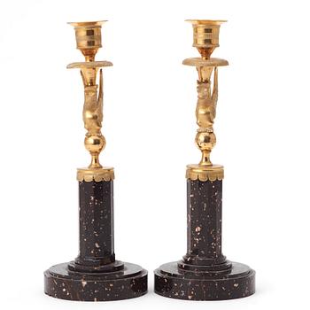 A pair of late Gustavian early 19th century porphyry and ormolu candlesticks.