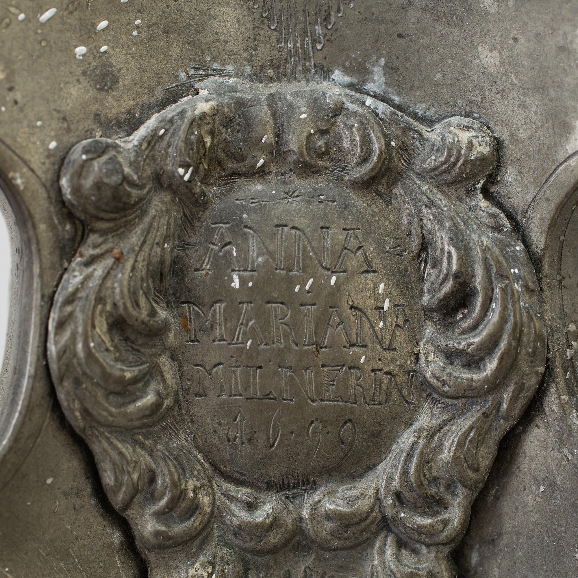 A pair of baroque pewter candlesticks, engraved date 1699.