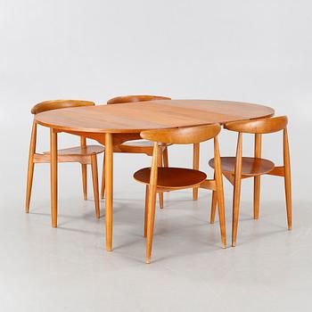 Four chairs named "Hjertestolen" designed by Hans J Wegner and a dining table from Troed.