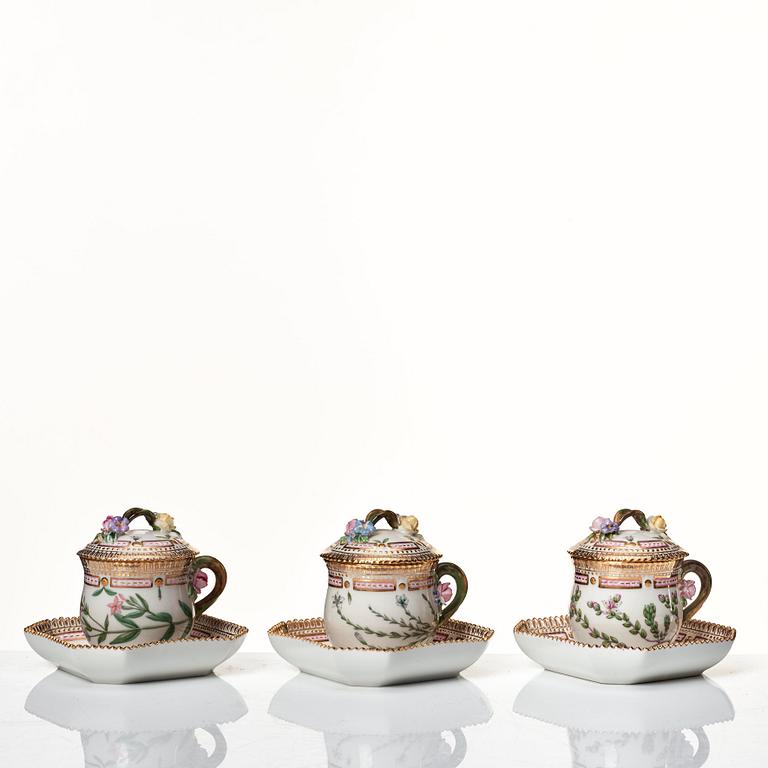 A set of 12 Royal Copenhagen 'Flora Danica' custard cups with covers and stands, Denmark, 20th Century.