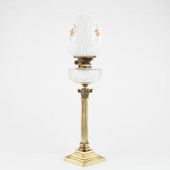 A brass and glass column shaped paraffin lamp, end of the 19th Century.