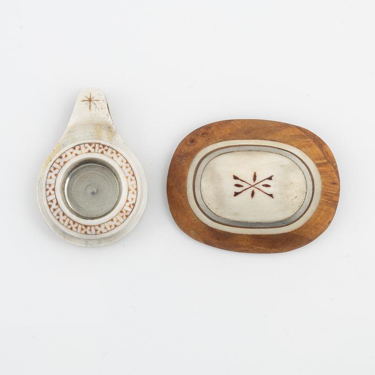 A brooch attributed to Per Sunna and a pendant, both in birch and engraved reindeer horn,