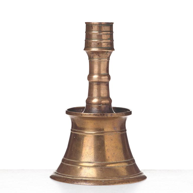 A CANDLESTICK, bronze/copper alloy, Ottoman, Turkey 16th-17th century, height 24 cm, the foot diameter 15,5 cm.