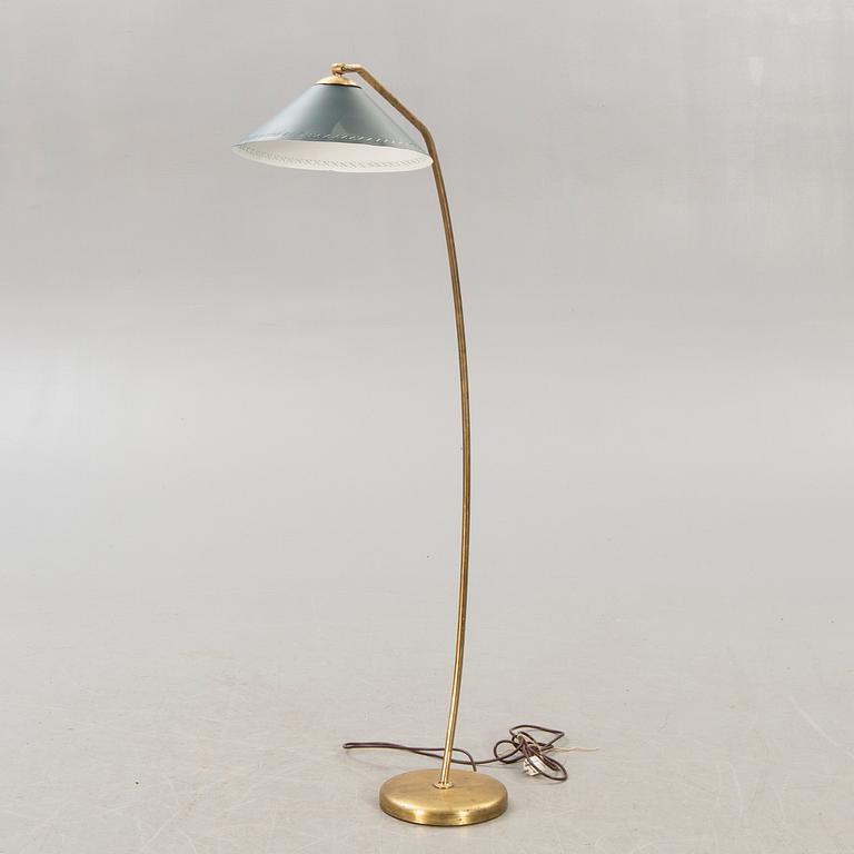 A 1950s brass floor lamp.