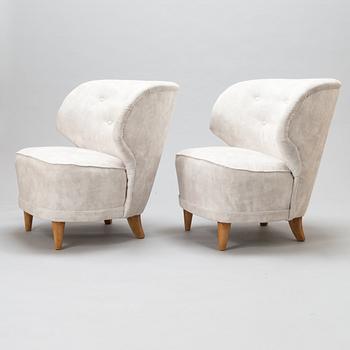 A pair of mid-20th-century armchairs.