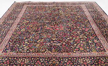 A carpet, Kerman, "Millefleur", signed, ca 396 x 291 cm.