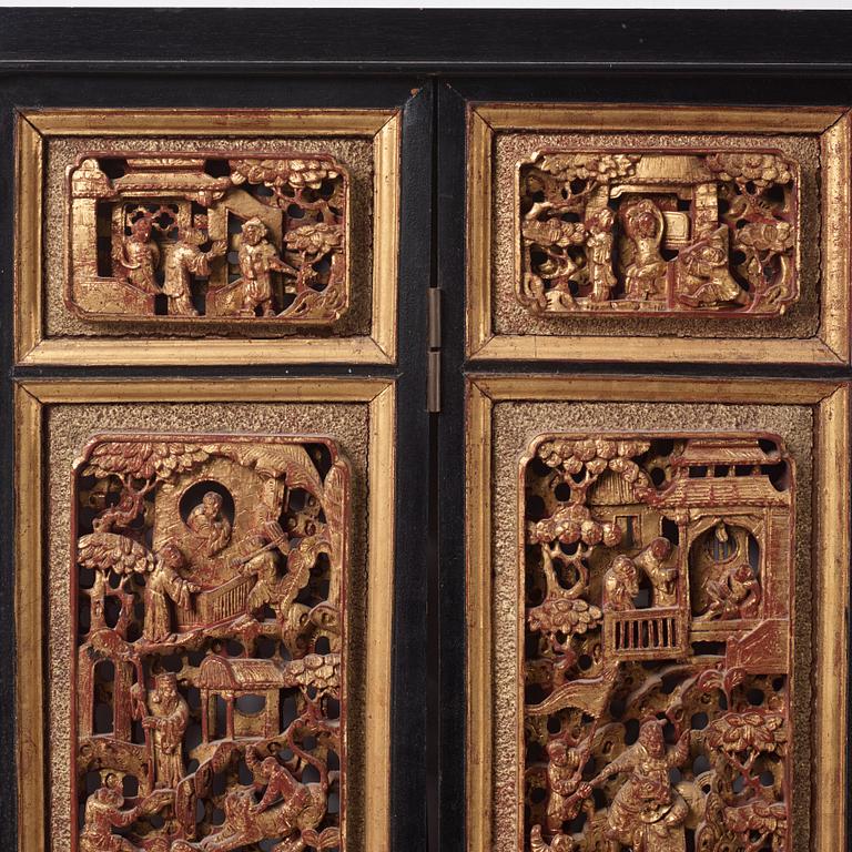 A set of four framed wooden panels, Qing dynasty, 19th Century.