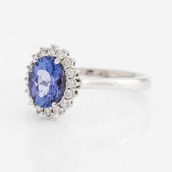 Ring in 18K gold with a faceted tanzanite and round brilliant-cut diamonds.