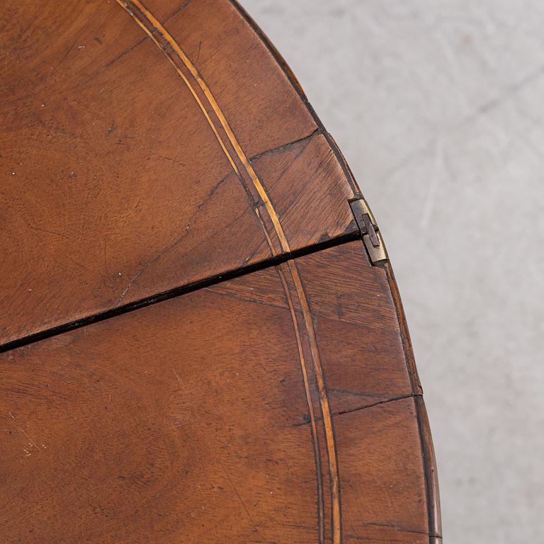 A mahogany-veneered table, presumably Denmark, Empire, first half of the 19th century.