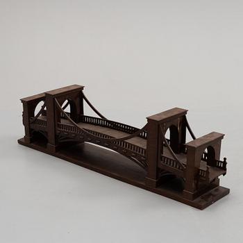 An early 20th century wood model of a bridge.