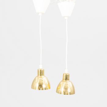 A pair of Hans-Agne Jakobsson brass ceiling pendants.