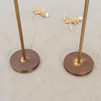 A pair of brass floor lamps from NK (Nordiska Kompaniet) later part of the 20th century.
