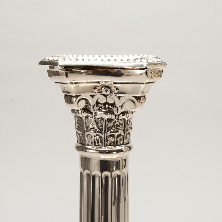 A pair of classical column sterling silver candlesticks Birmingham, 1934, by 'B.G. & Co'.