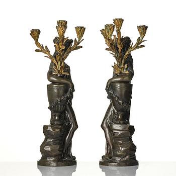 A pair of Louis XVI-style four-light gilt and patinated bronze candelabra after Clodion, later part 18th century.