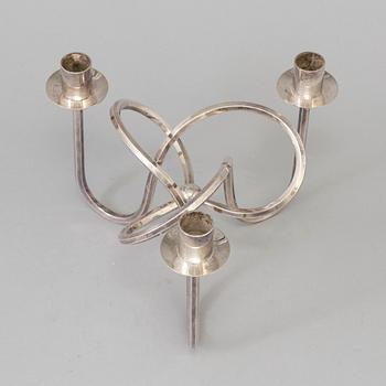 Josef Frank, a silver platen "Vänskapsknuten" candelabra ju Josef Frank för Firma Svenskt Tenn.