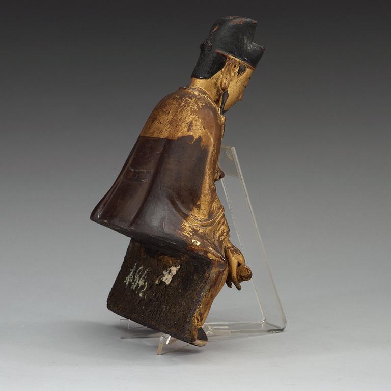 A gilt and lacquered wooden figure of a deity, Ming style.