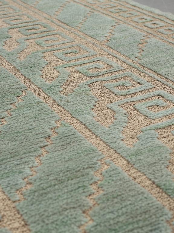 Märta Måås-Fjetterström, A carpet, "Vita spetsporten, grönblå", knotted pile in relief, ca 310,5-314 x 252 cm, signed MMF.