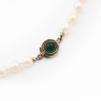 Cultured pearl necklace with Niels Erik From clasp, Denmark, silver set with a green cabochon-cut stone.