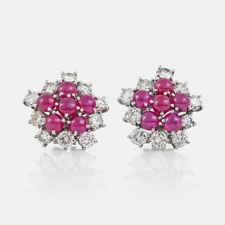 A pair of ruby, ca 4.00 cts, and diamond, circa 3.20 cts, earrings.