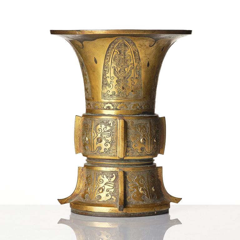 A parcel gilt/gold splashed bronze vase, Gu, 17/18th century.