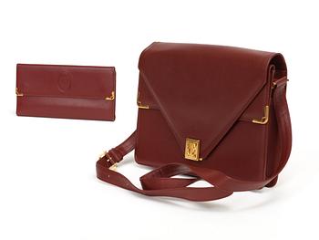 690. A wine red leather shoulder bag and wallet by Cartier.
