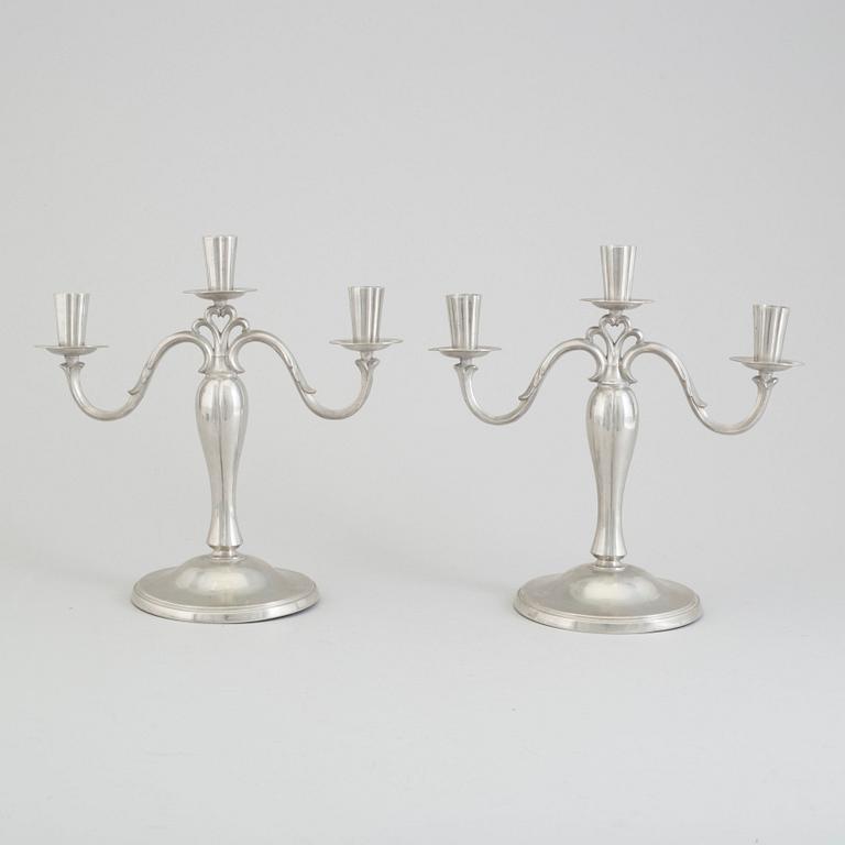 A pair of pewter candlesticks dated 1935.