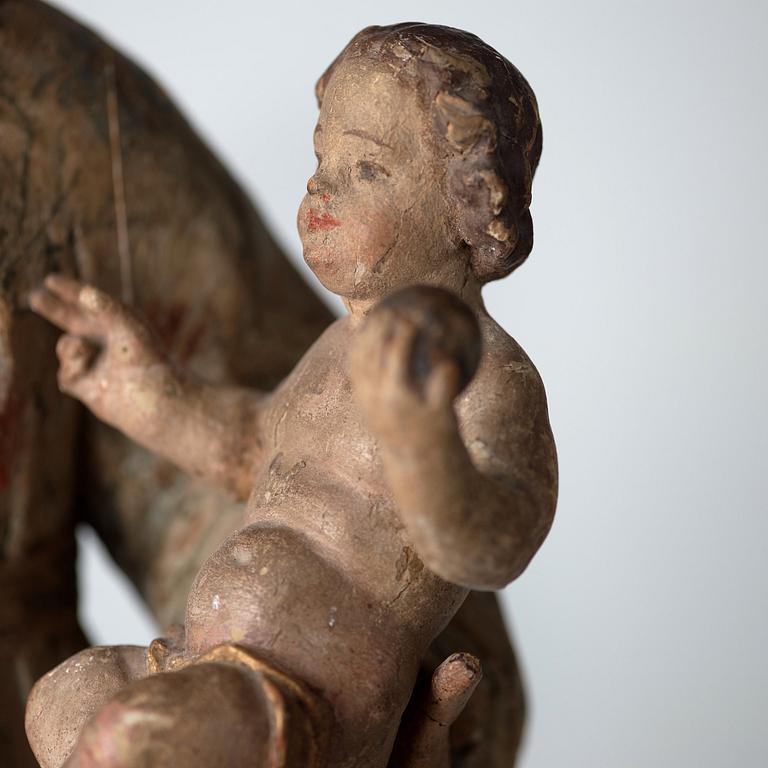 A Baroque 18th century sculpture depicting Mary with baby Jesus.