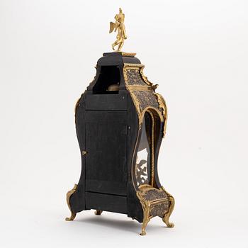 A 19th century rococo style clock, and a 18th century rococo console.