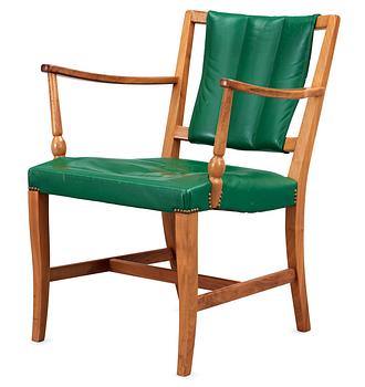 A Josef Frank mahogany and green leather armchair.