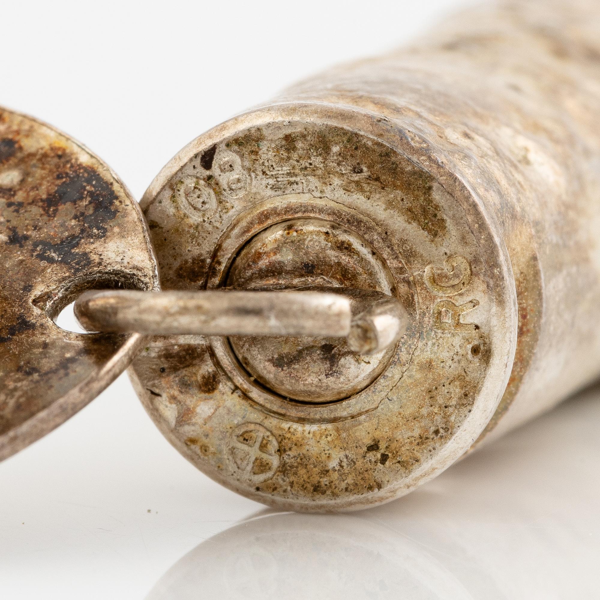 Earrings, possibly Slim Barrett.